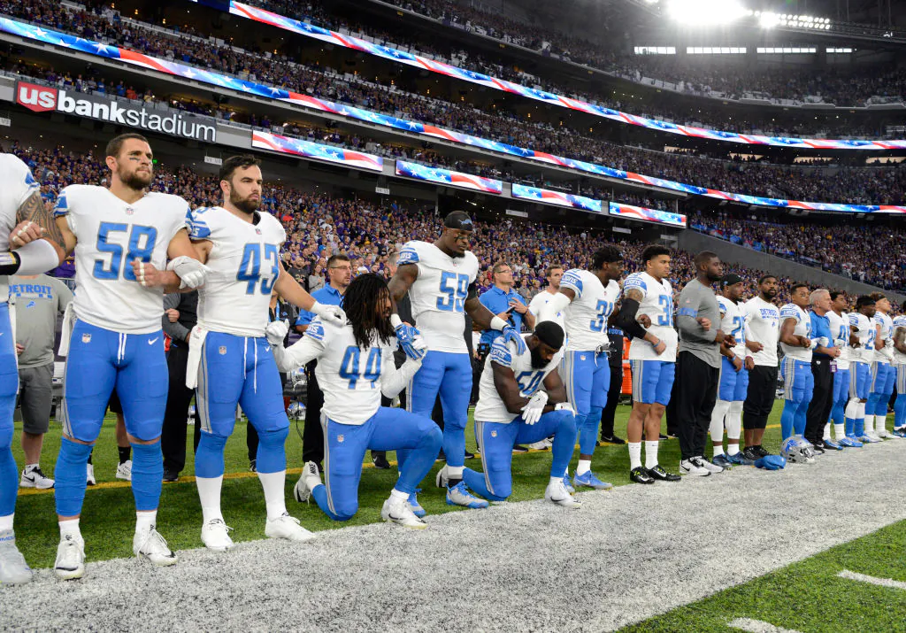 Jalen Reeves-Maybin( #44) of the Detroit Lions and teammate Steve Longa (#54) take a knee during the national anthem before the game against the Minnesota Vikings at U.S. Bank Stadium in Minneapolis, Minn., on Oct. 1, 2017. (Hannah Foslien/Getty Images)
