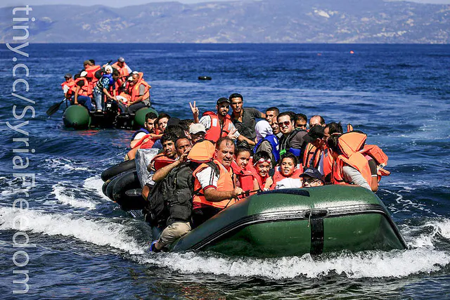 Syrian Refugees in plastic boats struggling to reach the coast. (Freedom House\Flicker, Public Domain)