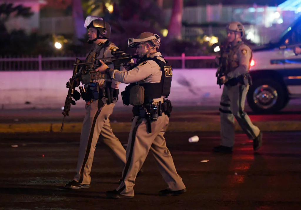 A police officer points his weapon at a car driving down closed Tropicana Ave. near Las Vegas Boulevard after a reported mass shooting at a country music festival nearby in Las Vegas on Oct. 2, 2017. (Ethan Miller/Getty Images)