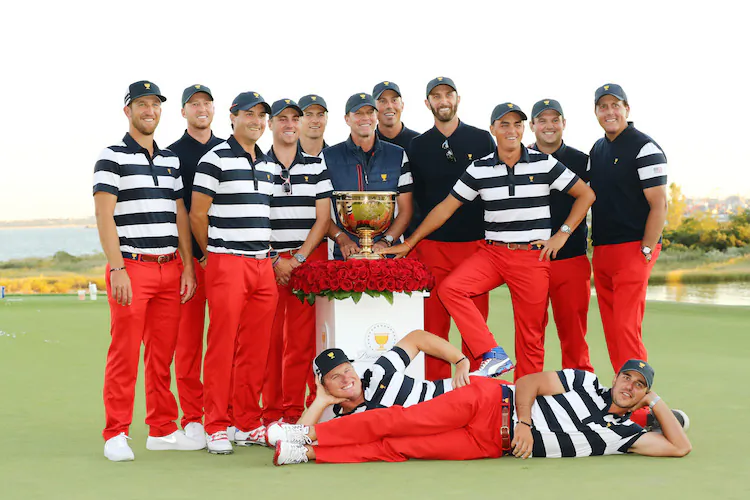 The U.S. team celebrates with the trophy after defeating the International team in the Presidents Cup at Liberty National Golf Club in Jersey City, New Jersey on Oct. 1, 2017. (Elsa/Getty Images)