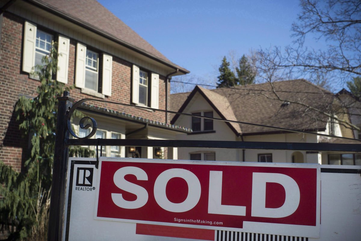 A sold sign is shown in front of a west-end Toronto home. (The Canadian Press/Graeme Roy)