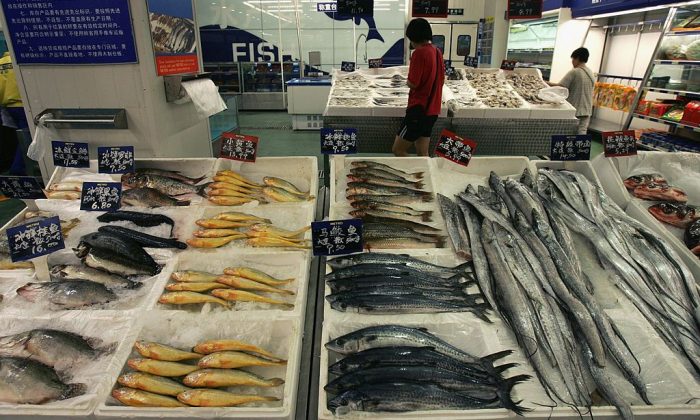 A customer shops for fish at a supermarket in Beijing, China.  (China Photos/Getty Images)