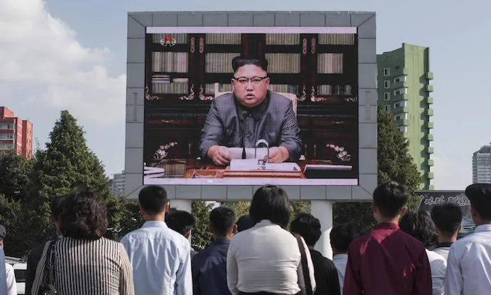 North Koreans watch a statement delivered by dictator Kim Jong Un on a television screen outside of the railway station in Pyongyang on Sept. 22. A top CIA analyst says Kim is not irrational and must face a strong threat from the United States in order to be restrained. (Ed Jones/AFP/Getty Images)