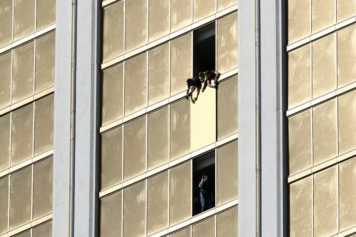 Workers board up a broken window at the Mandalay Bay Hotel on Oct. 6, 2017. (REUTERS/Chris Wattie)