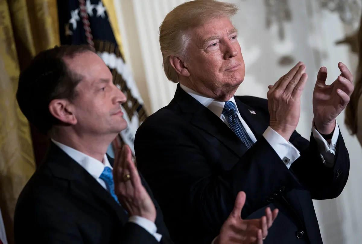 President Donald Trump and US Secretary of Labor R. Alexander Acosta clap during a Hispanic Heritage Month event in the East Room of the White House in Washington on Oct. 6, 2017. (BRENDAN SMIALOWSKI/AFP/Getty Images)
