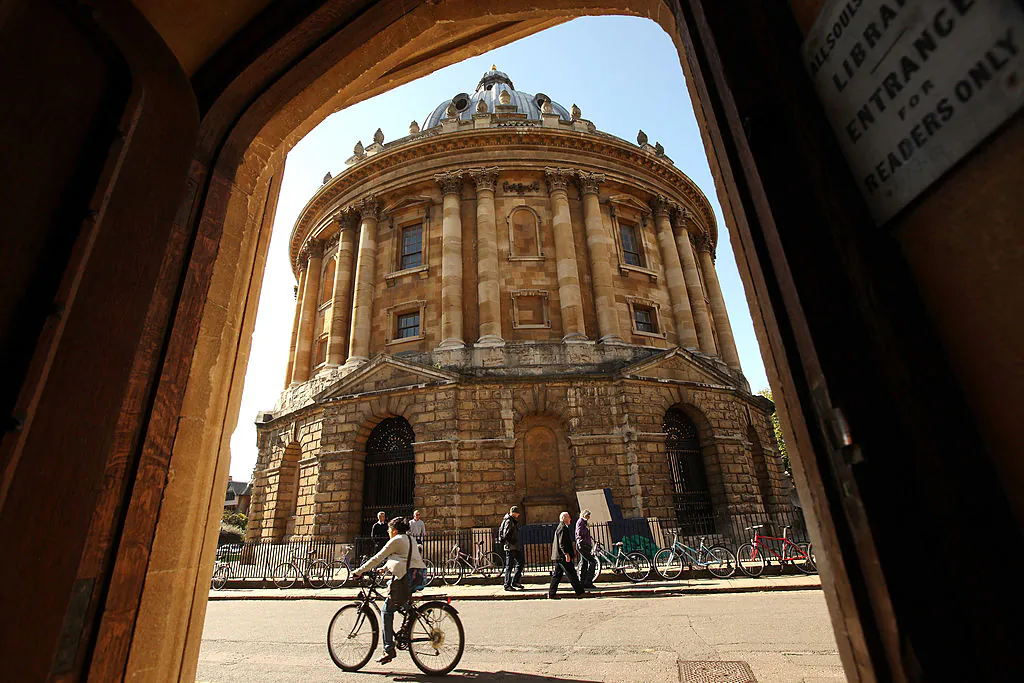 A cyclist travels past the Radcliffe Camera building of Oxford University in Oxford city centre. (Oli Scarff/Getty Images)