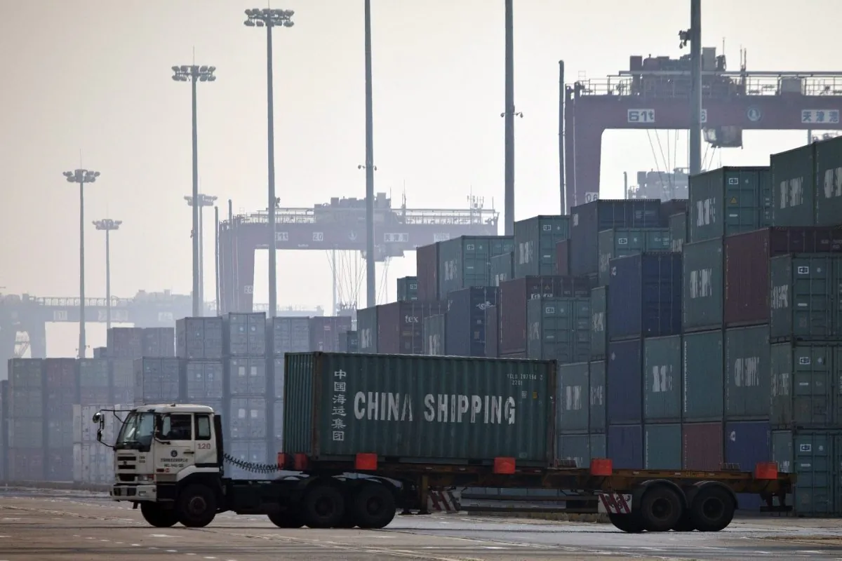 A truck transports a container to be loaded onto a ship at a port in Tianjin, China in October 2017. (Alexander F. Yuan/AP Photo)