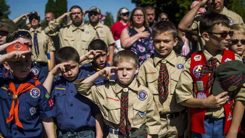In this Monday, May 29, 2017 file photo, Boy Scouts and Cub Scouts salute during a Memorial Day ceremony in Linden, Mich. On Wednesday, Oct. 11, 2017. (Jake May/The Flint Journal - MLive.com via AP)