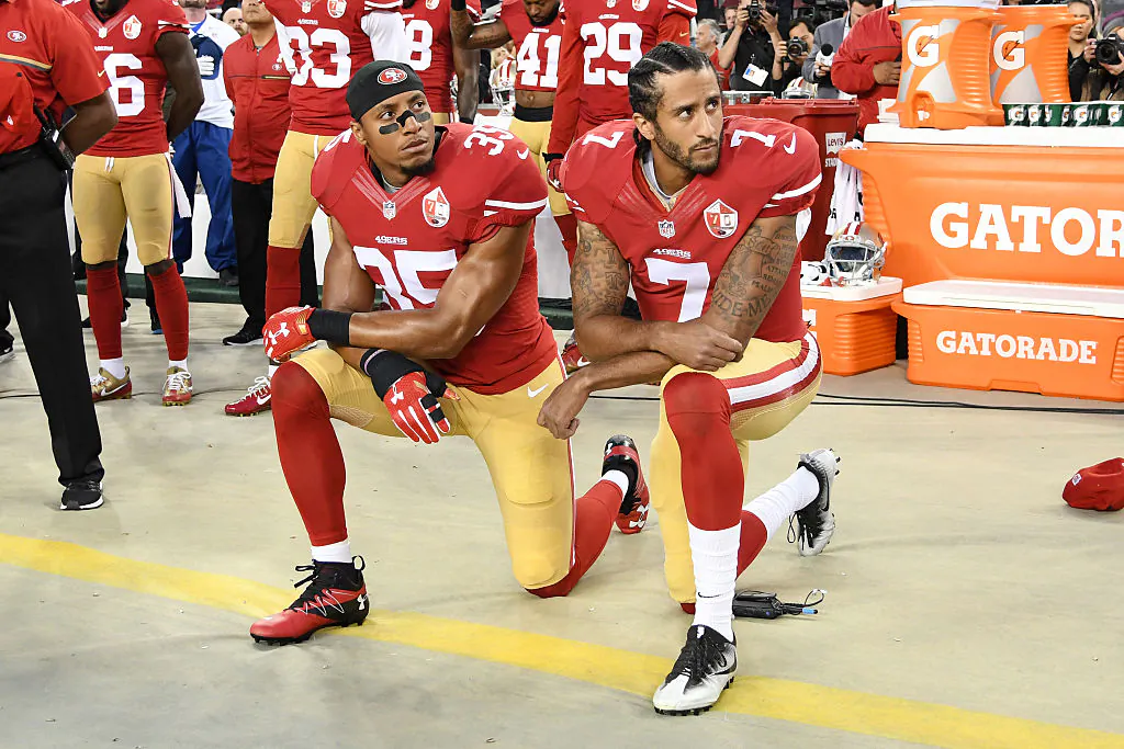 Colin Kaepernick #7 and Eric Reid #35 of the San Francisco 49ers kneel in protest during the national anthem prior to playing the Los Angeles Rams in their NFL game at Levi's Stadium in Santa Clara, California, on Sept. 12, 2016.  (Thearon W. Henderson/Getty Images)