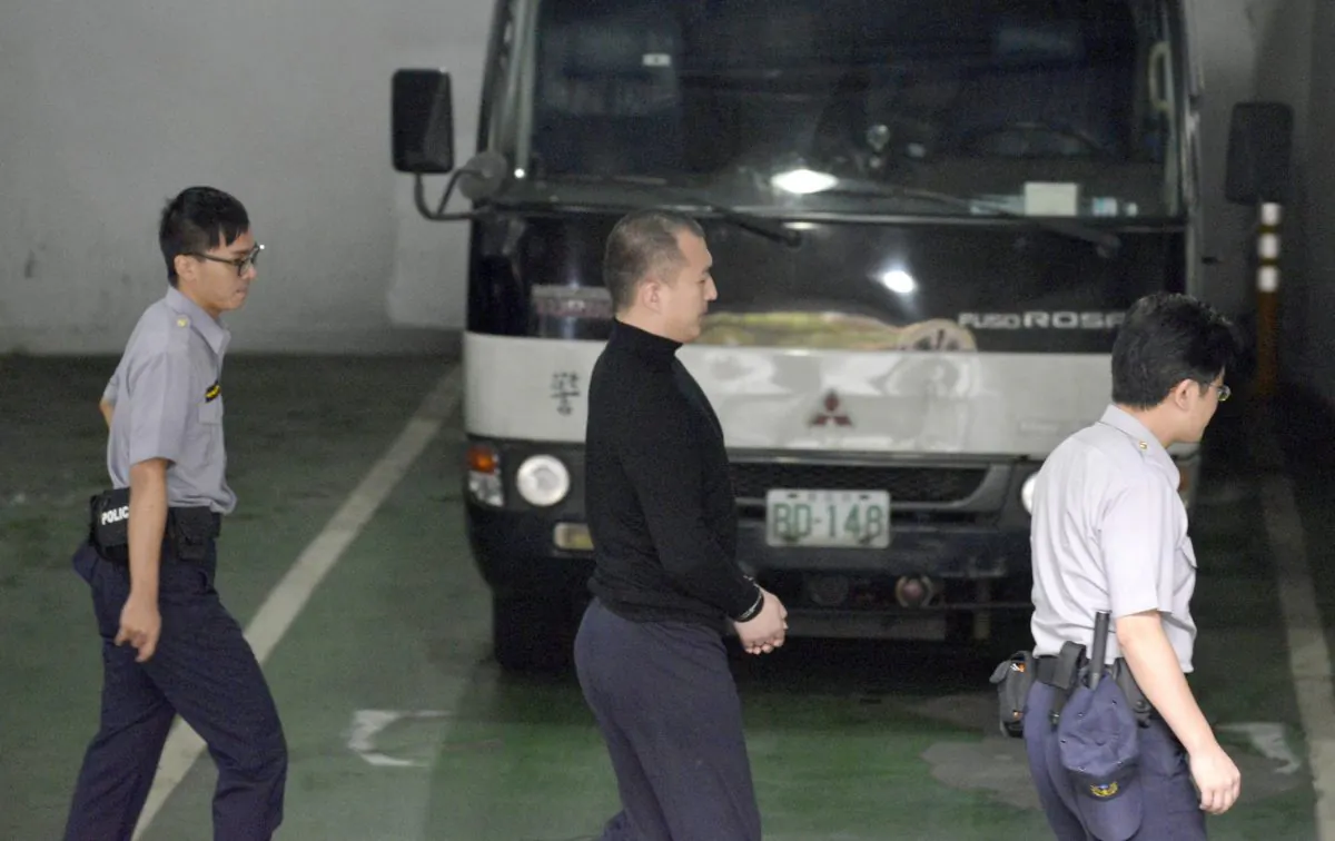 Zhou Hongxu (C), a Chinese student who was studying in Taiwan, was arrested there in March 2017 and sentenced to 14 months for attempting to recruit spies for China. Expert says that the Chinese regime has a comprehensive database of Taiwanese citizens that can help it identify targets to spy on or to recruit as agents against Taiwan. (SAM YEH/AFP/Getty Images)