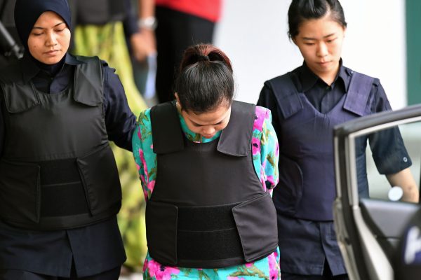 Indonesian defendant Siti Aisyah is escorted by police personnel following her appearance at the Malaysian Chemistry Department in Petaling Jaya, outside Kuala Lumpur on October 9, 2017, as part of the ongoing trial for her alleged role in the assassination of Kim Jong-Nam, the half-brother of North Korean leader Kim Jong-Un. (Mohd Rasfan/AFP/Getty Images)