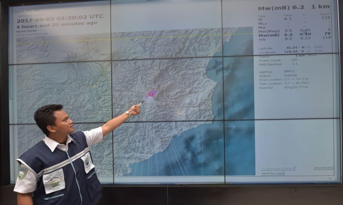 An Indonesian official at Indonesia's Meterological, Climatological and Geophysical Agency (BMKG)  points to a map of North Korea showing where the agency recorded a magnitude-6.2 earthquake caused by a North Korean nuclear test on Sept. 3, 2017. (Adek Berry/AFP/Getty Images)