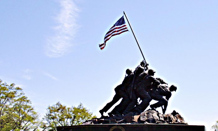 In this file photo, a U.S. Marine Corp squad practices in front of the Iwo Jima Memorial on April 26, 2005 in Arlington, VA. The memorial depicting the famous flag raising on the island of Iwo Jima during World War II honors all Marines who have fallen in all war and can be taken as a symbol of unity in the United States. (KAREN BLEIER/AFP/Getty Images)