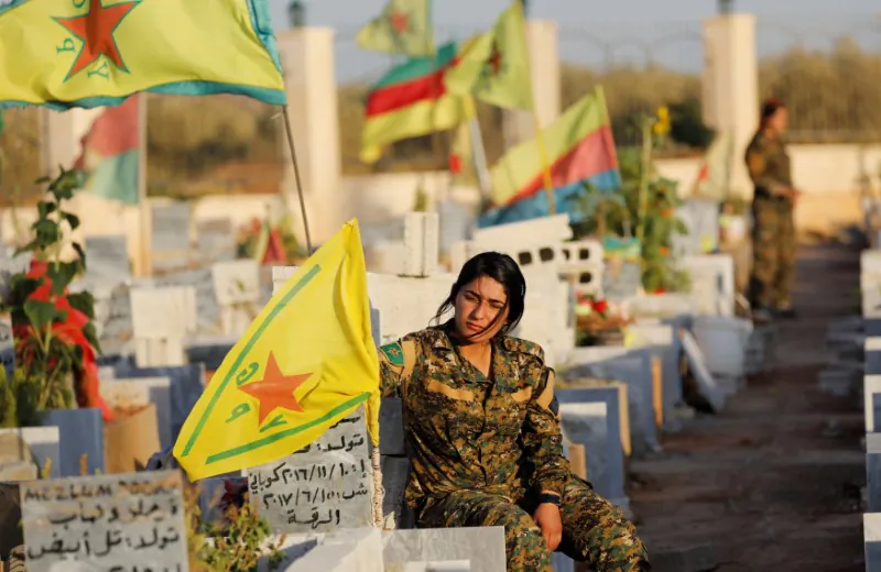 Fighters of Syrian Democratic Forces visit the graves of their late comrades at a cemetery for those fighters killed during fightings with ISIS terrorists in Kobani, Syria October 11, 2017. Picture taken October 11, 2017. (Reuters/Erik De Castro)
