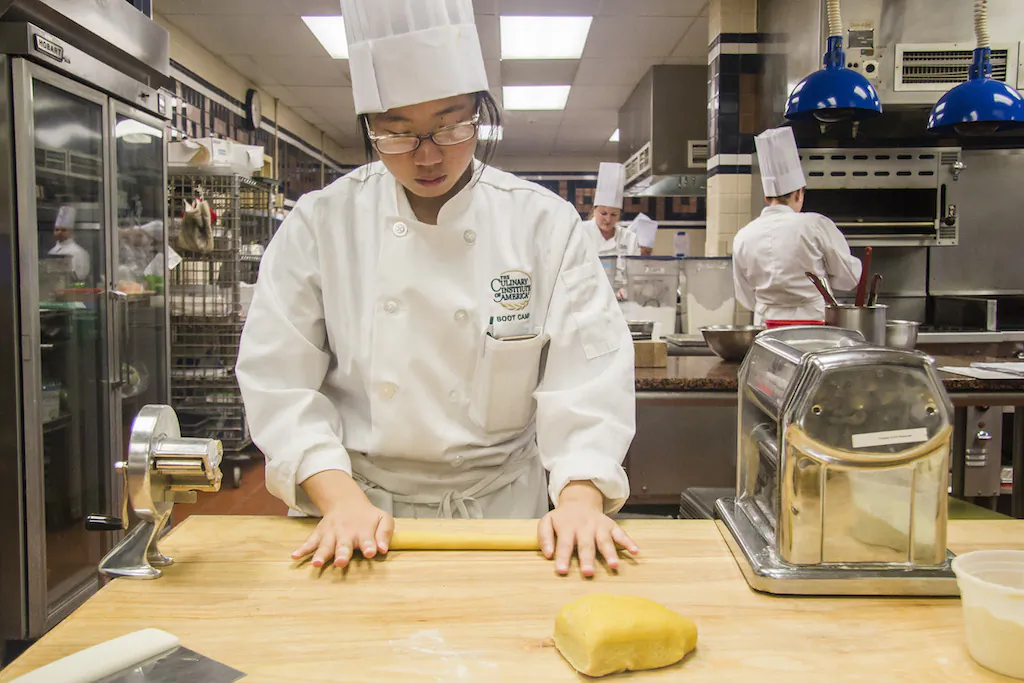 Reporter Annie Wu learns to make fresh pasta for a cavatelli dish at the CIA’s Italian boot camp in Hyde Park, N.Y., on July 27. (Pruitt Kerdchoochuen)