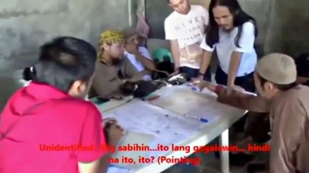 Men identified by Philippines Intelligence officers as Isnilon Hapilon (2nd L, yellow headscarf) and Abdullah Maute (2nd R, standing, long hair) are seen in this still image taken from video released by the Armed Forces of the Philippines on June 7. (Armed Forces of the Philippines/Handout via REUTERS TV)