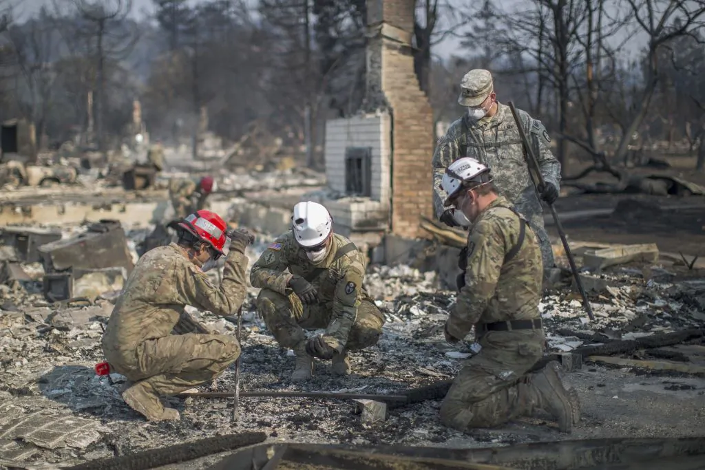California National Guardsmen find bones at a fire-devastated home near Mark West Springs Road and Old Redwood Highway on October 15, 2017 in Santa Rosa, California. After further investigation the bones were thought to be non-human.  At least 40 people are confirmed dead, dozens are still missing, and at least 5,700 buildings have been destroyed since wildfires broke out a week ago.  (David McNew/Getty Images)