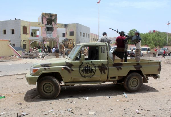 Yemeni security forces stand guard with a machine gun at the site of a suicide car bombing claimed by the Islamic State group on August 29, 2016 at an army recruitment centre in the southern Yemeni city of Aden. (Saleh Al-Obeidi/AFP/Getty Images)