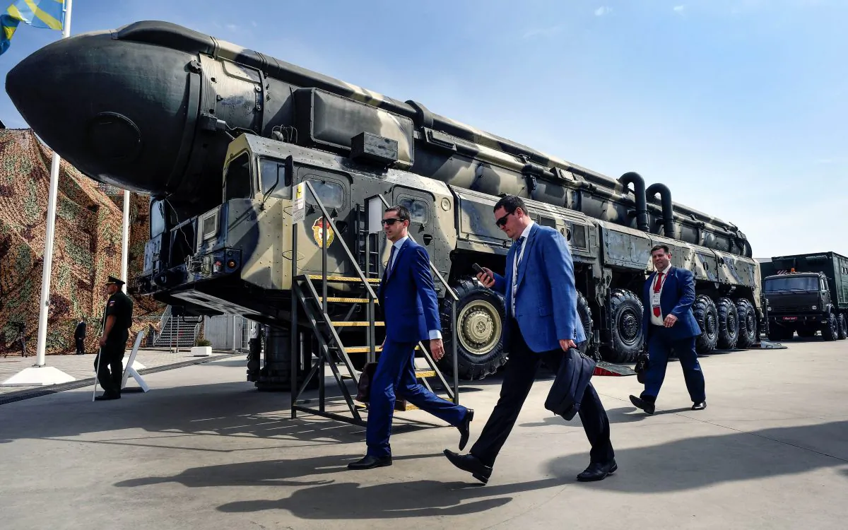 Military specialists walk past a Russian Topol intercontinental ballistic missile (ICBM) at the exposition field in Kubinka Patriot Park outside Moscow on Aug. 22, 2017. (Alexander Nemenov/AFP/Getty Images)
