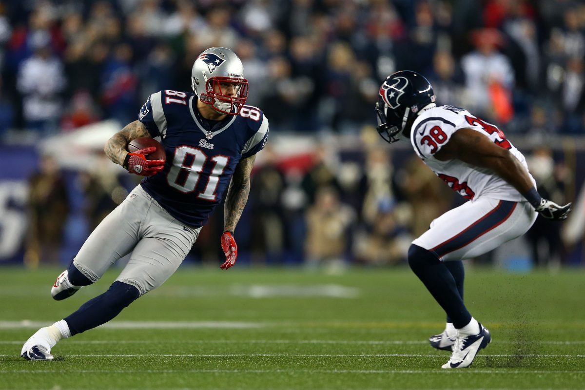 Aaron Hernandez #81 of the New England Patriots runs with the ball against Danieal Manning #38 of the Houston Texans during the 2013 AFC Divisional Playoffs game at Gillette Stadium on January 13, 2013 in Foxboro, Massachusetts. (Elsa/Getty Images)