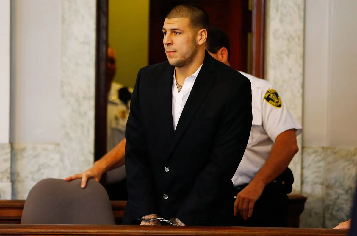 Aaron Hernandez is escorted into the courtroom of the Attleboro District Court for his hearing in North Attleboro, Massachusetts, on Aug. 22, 2013. Former New England Patriot Aaron Hernandez was indicted on a first-degree murder charge for the death of Odin Lloyd. (Jared Wickerham/Getty Images)