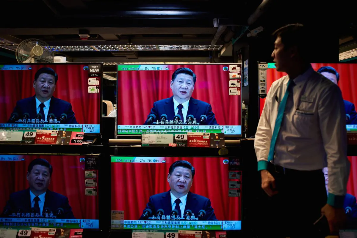 An electronics shop in Hong Kong with television sets showing a news report on Xi Jinping's speech at the opening session of the Chinese Communist Party's 19th National Congress, on October 18, 2017. (Anthony Wallace/AFP/Getty Images)