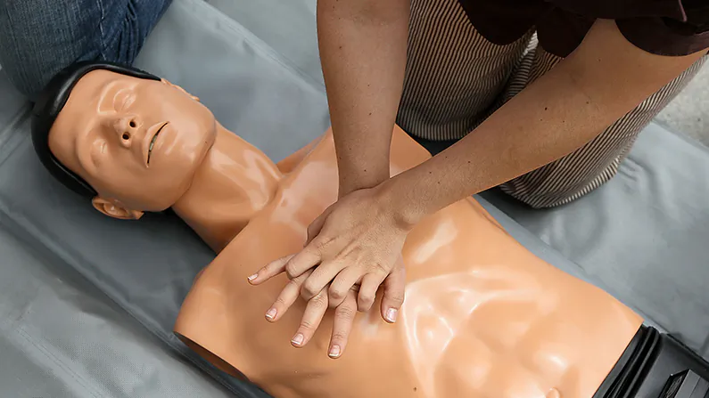A woman performs chest compressions on a mannequin while learning C.P.R. on the steps of San Francisco city hall following a press conference celebrating the 50th anniversary of lifesaving by using C.P.R. June 1, 2010 in San Francisco, California. (Justin Sullivan/Getty Images)