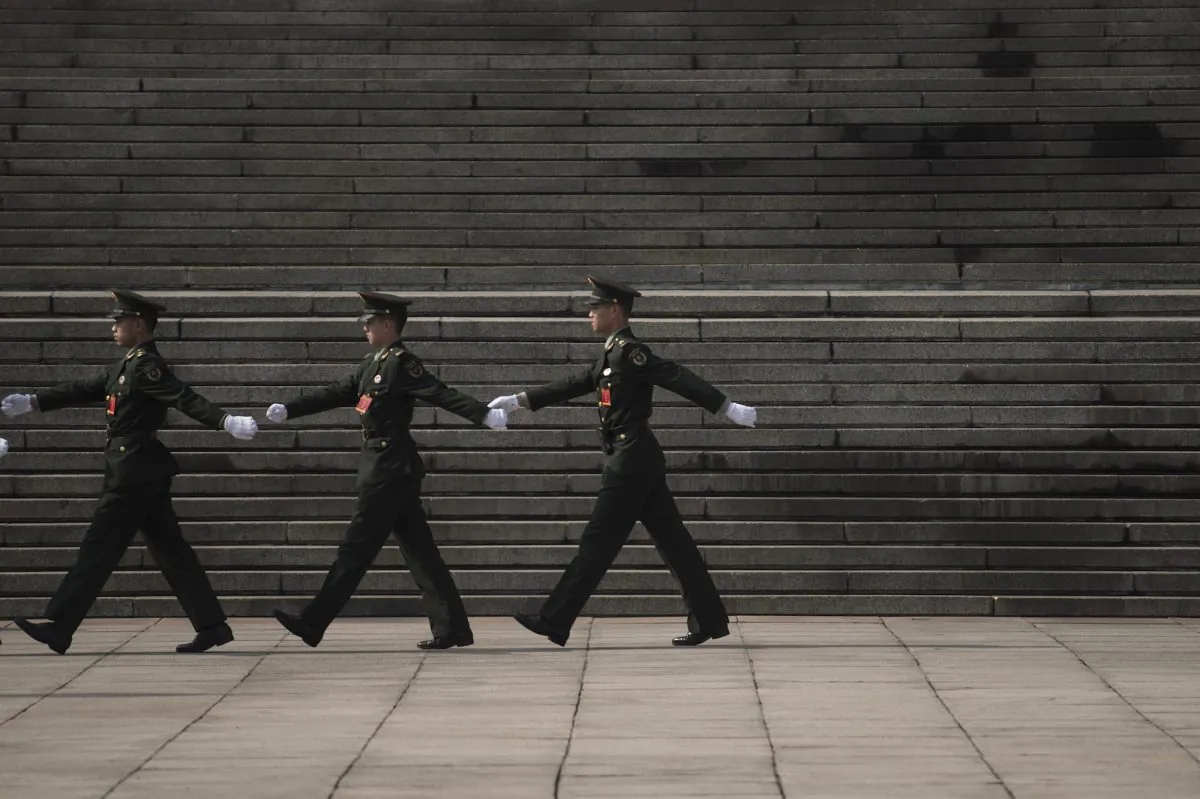 Chinese paramilitary guards walk in front of the Great Hall of the People during the 19th National Congress in Beijing on Oct. 19, 2017. (Fred Dufour/AFP/Getty Images)