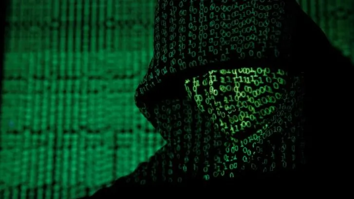A projection of cyber code on a hooded man is pictured in this illustration picture taken on May 13,  2017. (Kacper Pempel/Illustration/Reuters)