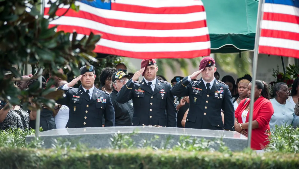 Members of the 3rd Special Forces Group, 2nd Battalion salute the casket of U.S. Army Sgt. David Johnson at his burial service in the Memorial Gardens East cemetery on Oct. 21, 2017, in Hollywood, Fla. (Gaston De Cardenas/AFP/Getty Images)