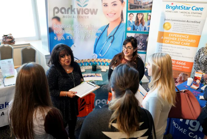 Job seekers listen to a recruiter at the Colorado Hospital Association job fair in Denver, Colo., on Oct. 4, 2017. (Rick Wilking/Reuters/File Photo)