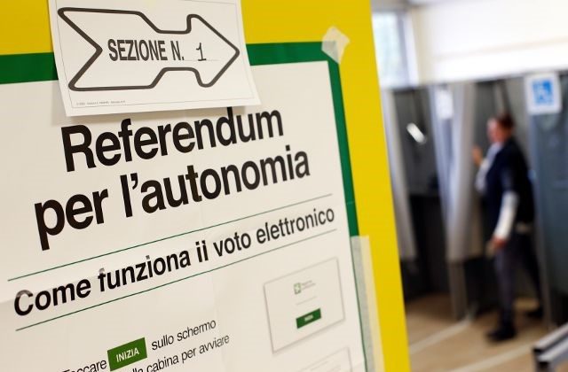A poster with instructions about Lombardy's autonomy referendum is seen at a polling station in Lozza near Varese, northern Italy, October 22, 2017.  (Reuters/Alessandro Garofalo)