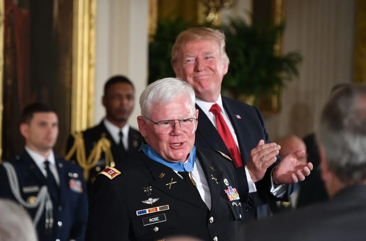 President Donald Trump claps after presenting the Medal of Honor to
retired U.S. Army Capt. Gary Michael Rose for his actions during the Vietnam
War, on Oct. 23, 2017.