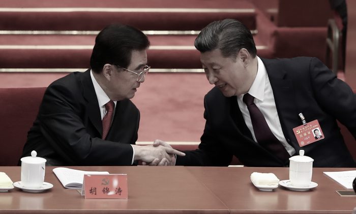 Chinese leader Xi Jinping (R) shakes hands with Hu Jintao, his predecessor, during the opening session of the 19th National Congress in Beijing on Oct. 18, 2017. (Lintao Zhang/Getty Images)