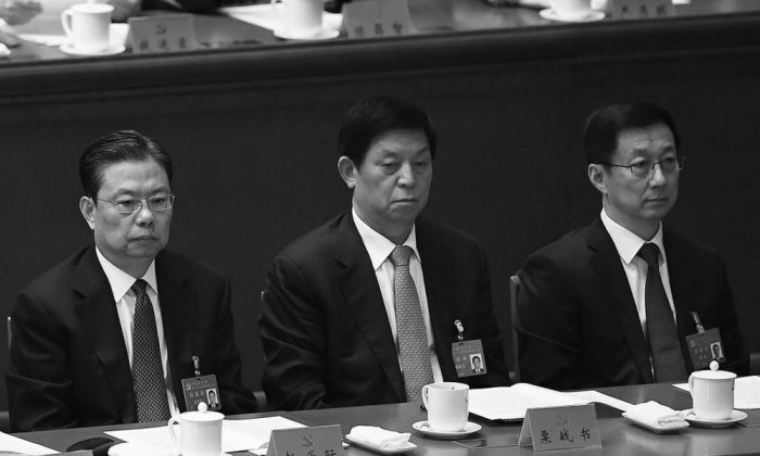 Han Zheng (R) talks to Li Zhanshu (C) and Zhao Leji (L) at the closing session of the 19th National Congress on Oct. 24, 2017. All three are newly appointed to the Chinese Communist Party's top decision-making body,
the Politburo Standing Committee. (Wang Zhao/AFP/Getty Images)