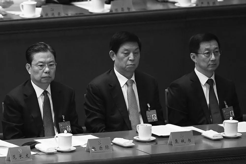 Han Zheng (R) talks to Li Zhanshu (C) and Zhao Leji (L) at the closing session of the 19th National Congress on Oct. 24, 2017. All three are newly appointed to the Chinese Communist Party's top decision-making body,
the Politburo Standing Committee. (Wang Zhao/AFP/Getty Images)