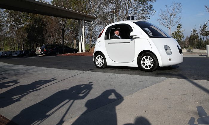 Google Chairman Eric Schmidt sits in a Google self-driving car at the Google headquarters on February 2, 2015 in Mountain View, California.    (Justin Sullivan/Getty Images)