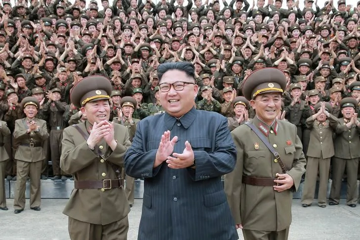 North Korean leader Kim Jong Un claps with military officers at the Command of the Strategic Force of the Korean People's Army (KPA) in an unknown location in North Korea in this undated photo released by North Korea's Korean Central News Agency (KCNA) on Aug. 15, 2017. (KCNA/via REUTERS)