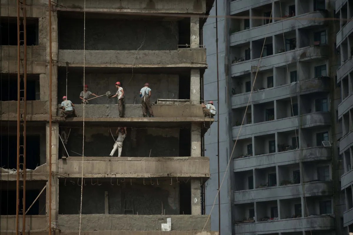 Laborers work on in Pyongyang on July 29, 2013. North Korea’s widespread use of slave labor is targeted in the State Department's latest report on the regime’s abuses of North Koreans. (Ed Jones/AFP/Getty Images)
