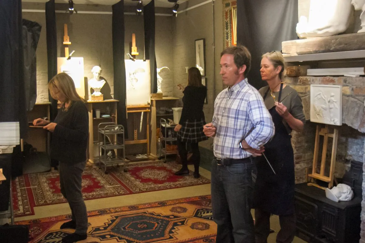 Co-founder and director of The Barnes Atelier of Art, Travis Seymour reviews a student's work in his atelier in London on Sept. 12, 2017. (Milene Fernandez/The Epoch Times)