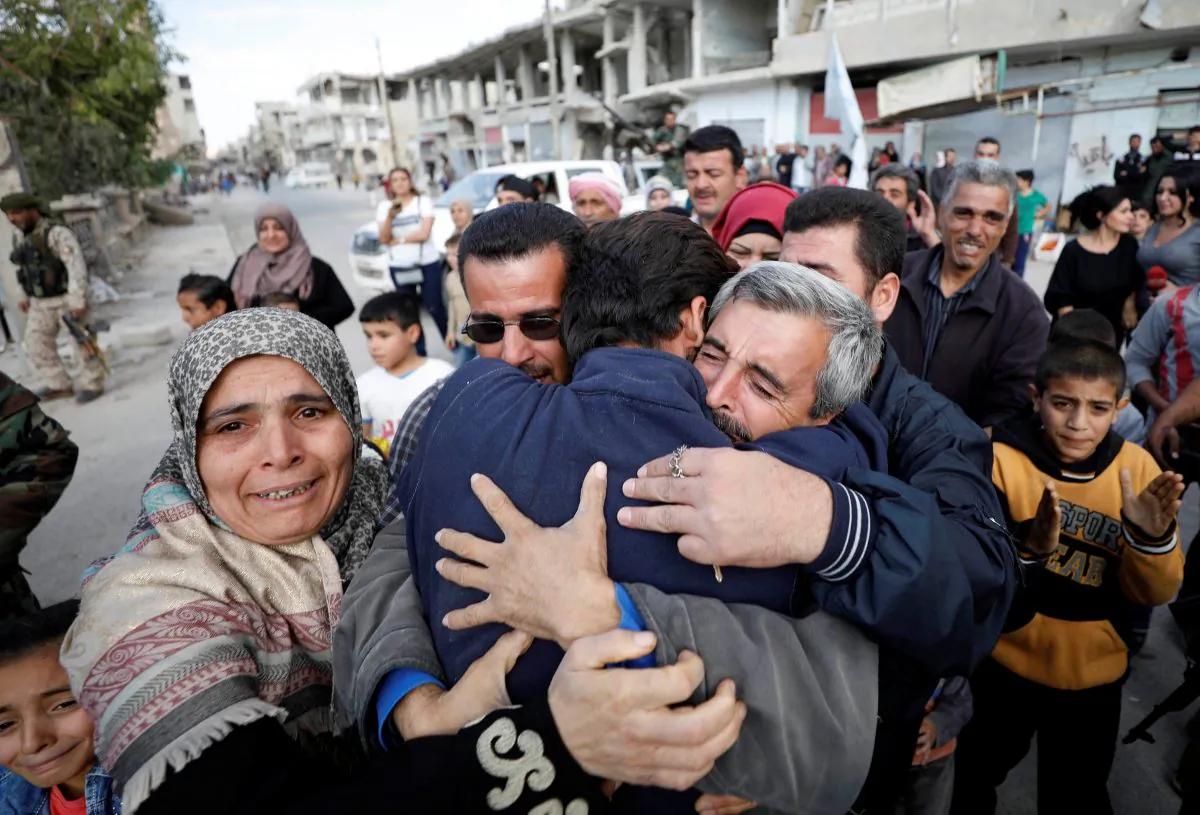 Relatives hug one of the hostages held by ISIS terrorists who escaped from his captors in Qaryatayn town in Homs province, Syria Oct. 29, 2017. (REUTERS/Omar Sanadiki)