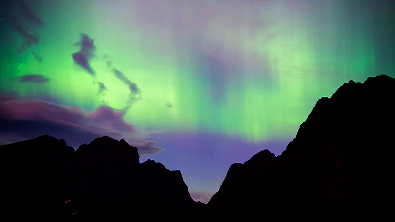 Northern lights (aurora borealis) illuminate the sky over Reinfjorden in Reine, on Lofoten Islands, Arctic Circle, on September 8, 2017./Photographers waiting for the Northern Lights in Siberia on the night of Oct. 26 saw an unexpected sight. (Jonathan Nackstrand/AFP/Getty Images)