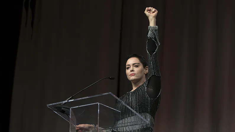 Actress Rose McGowan raises her fist during her opening remarks to the audience at the Women's March / Women's Convention in Detroit, Michigan, on October 27, 2017. (Rena Laverty/AFP/Getty Images)