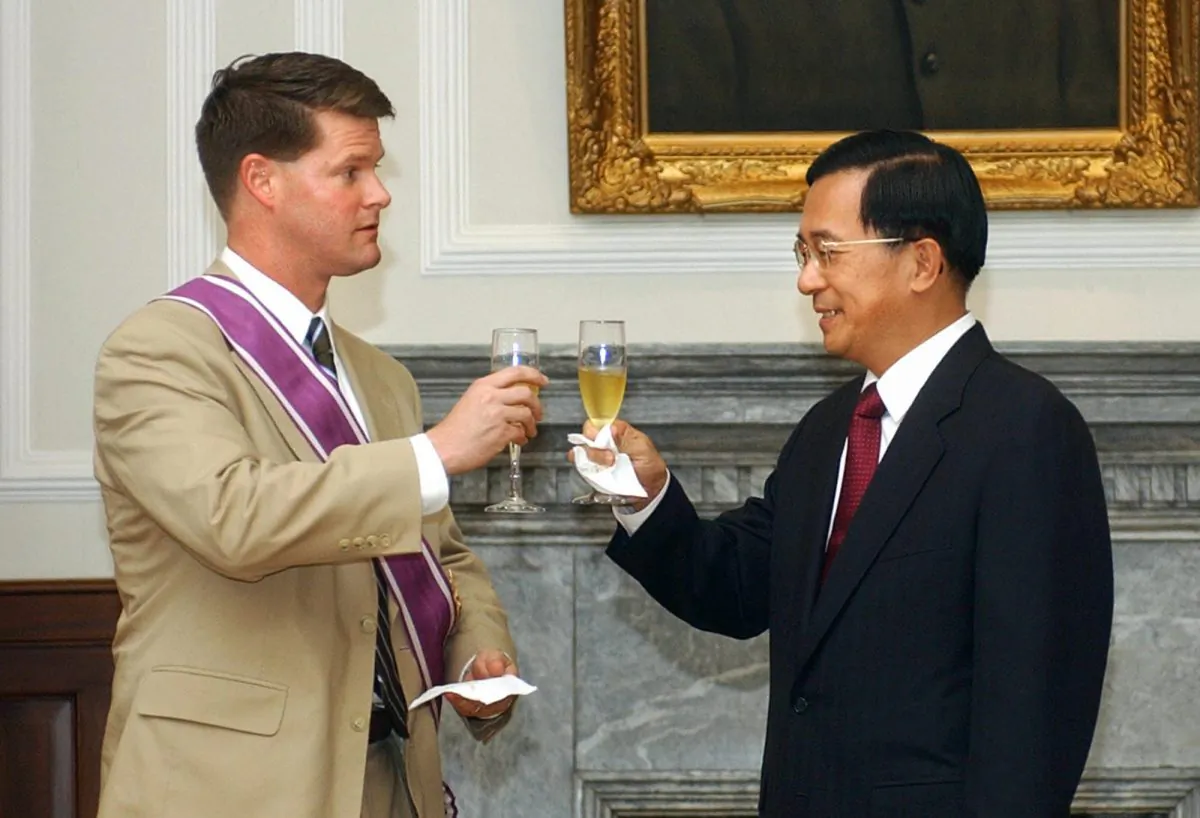 In this file photo, the Former US deputy assistant secretary of state for East Asia and Pacific affairs Randall Schriver (L) toasts with then-Taiwan's President Chen Shui-bian during a meeting at the Presidential Palace, July 12, 2005 in Taipei. President Donald Trump has nominated Schriver, who enjoys a reputation as a strong supporter of Taiwan, to be assistant secretary of defense for Asian and Pacific Affairs. (JEROME FAVRE/AFP/Getty Images)