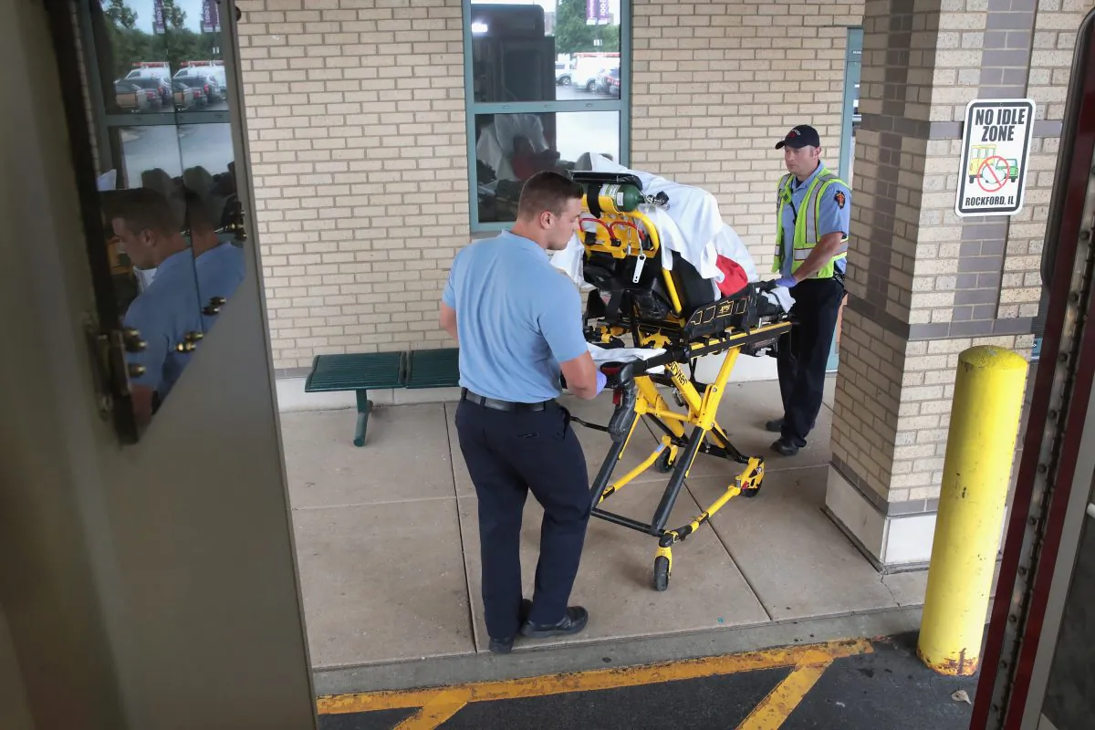 Firefighters transport an overdose victim to a hospital emergency room in Rockford, Ill., on July 14, 2017. The woman was found on the floor of the hotel room in which she lived after taking an overdose of prescription medication and alcohol. (Scott Olson/Getty Images)