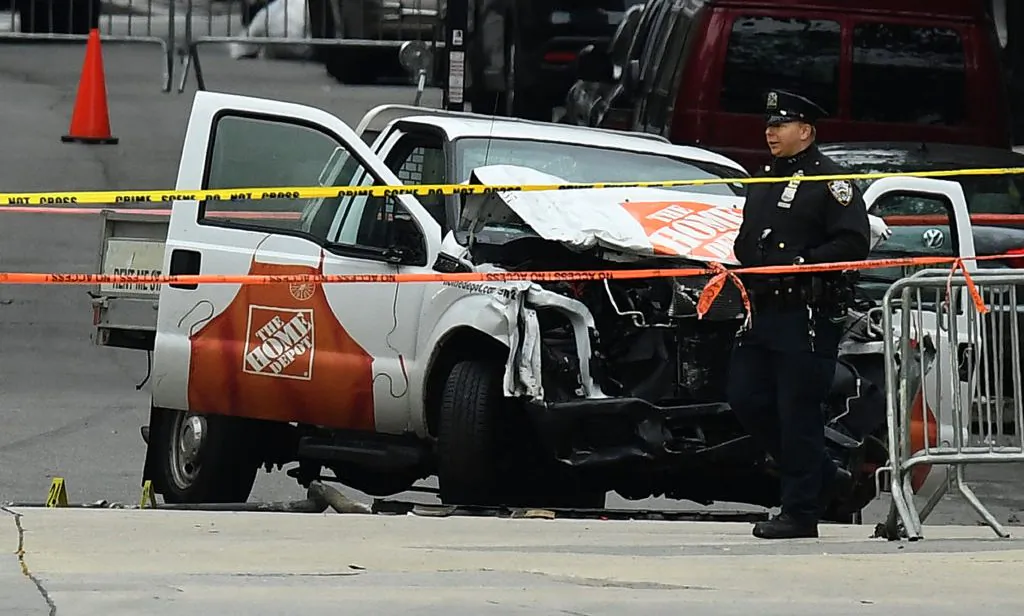 A police officer walks past the wreckage of a Home Depot pickup truck on November 1, 2017, a day after it was used in a terror attack in New York City. (JEWEL SAMAD/AFP/Getty Images)