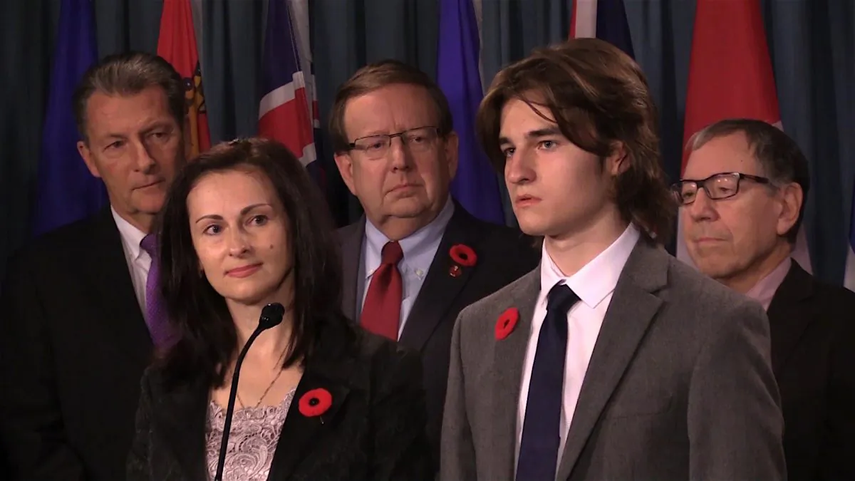 Sergei Magnitsky’s widow, Natalia, and their son, Nikita, speak at a press conference in Ottawa on Nov. 1, 2017, while former MP and minister of justice Irwin Cotler (R),  Senator Percy Downe (C), and MP John McKay listen in the background. (Limin Zhou/NTD Television)
