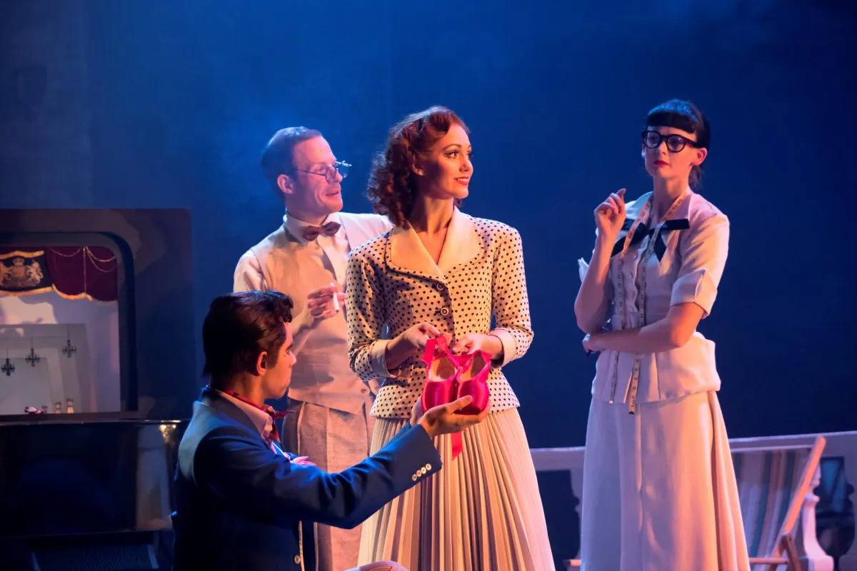 Ashley Shaw (center) as Victoria Page, surrounded by the company, in “The Red Shoes.” (Johan Persson)