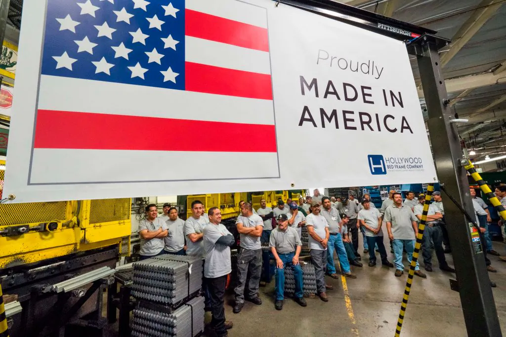 Workers at the Hollywood Bed Frame Company attend an event to mark the company's upcoming expansion, which will double the manufacturer's workforce, adding 100 new local jobs, at the company's factory in Commerce, Calif., on April 14, 2017. (ROBYN BECK/AFP/Getty Images)