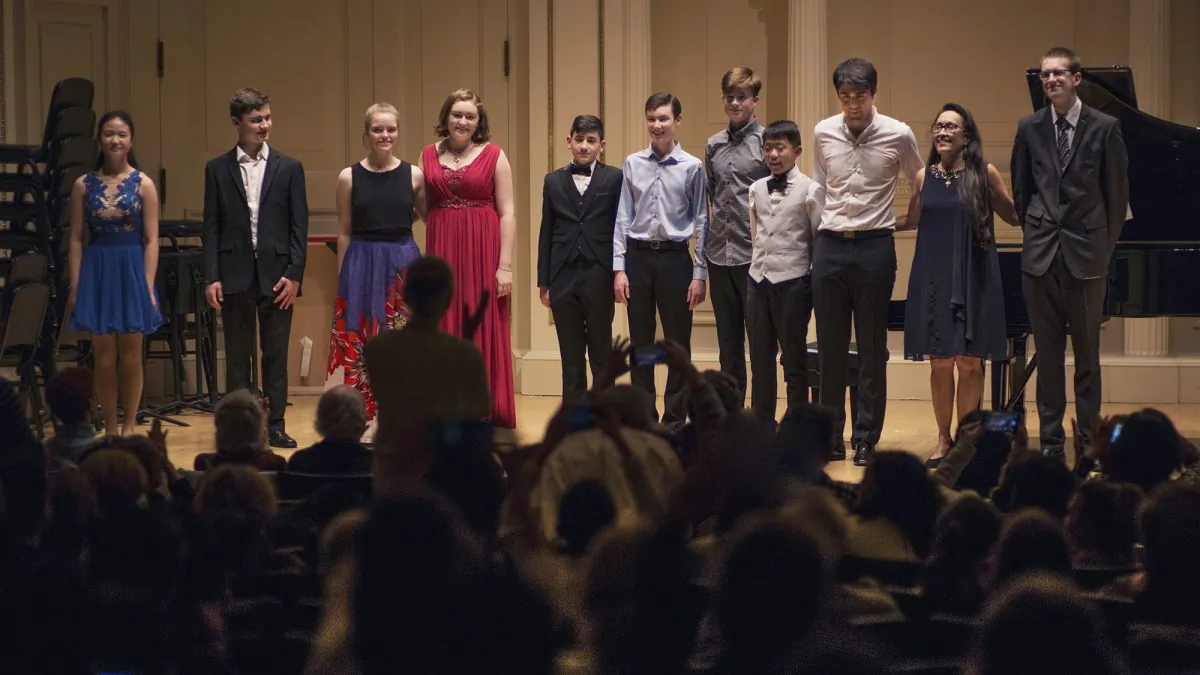 The New York Concerti Sinfonietta presented its 2017 International Shining Star Competition winners to a sold-out audience and introduced Conor Palliser as conductor at Carnegie Hall’s Weill Recital Hall on Oct. 29. (L–R), Tiffany Qiu, piano; Kevin Jansson, violin and piano; Zoë Nagle, cello; Ellen Jansson, piano; David Blake, cello; Oliver Neubauer, violin; Eoghan Doody, guitar; Gerry Yang, piano; David Tobin, violin; Julie Jordan, founder and artistic director; and Conor Palliser, conductor. (James Eden)